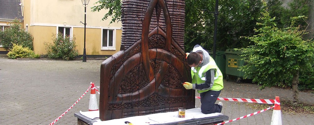 touching-up-timber-sculptures-in-ennis-2011