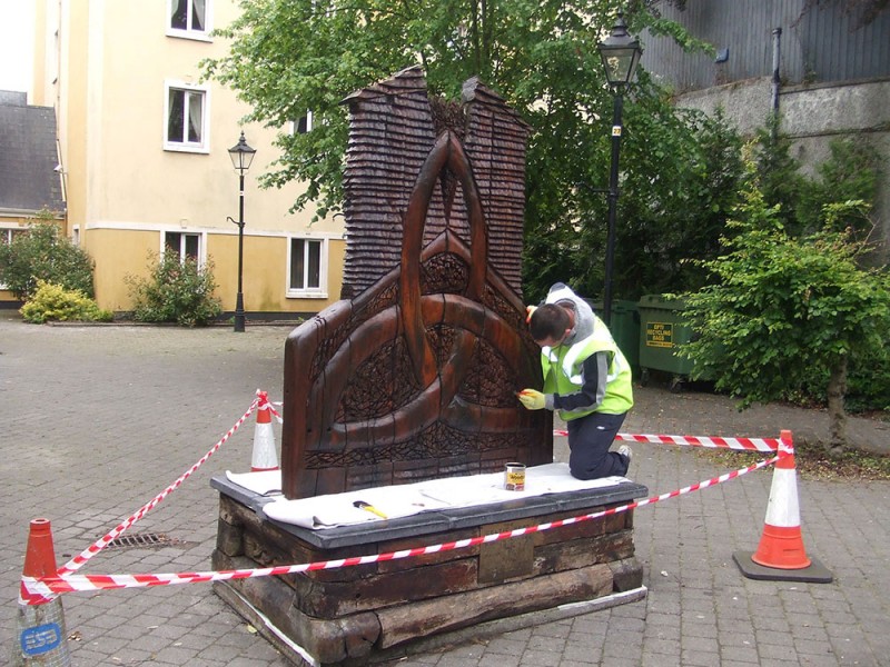 touching-up-timber-sculptures-in-ennis-2011